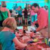 The fish table was a busy place. Here Chris now takes a turn helping fans make fish puppets while David is off cutting out more. Fred and Susie fans made more than 60 fish in the first 2 hours we were there!